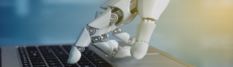 Robot hand typing on the laptop keyboard